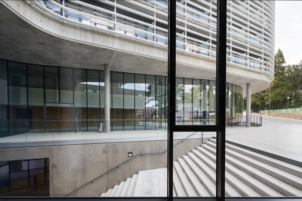 L’accès au rez-de-chaussée bas, semi-enterré, se fait par un large escalier en béton. L’accès au rez-de-chaussée bas, semi-enterré, se fait par un large escalier en béton.