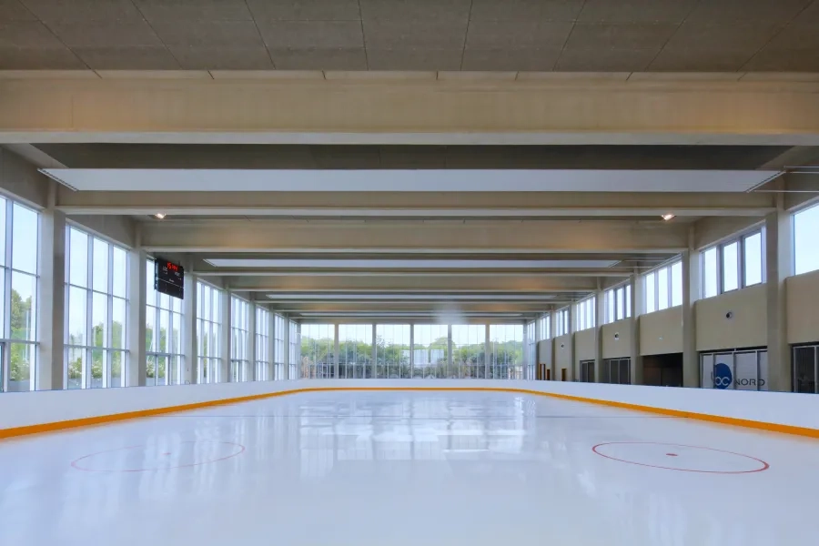 La piste de la patinoire synthétique. Les trois façades entièrement vitrées et la structure en béton laissé apparent contribuent à la qualité spatiale de cette grande halle. DEPRICK_MANIAQUE_Roye_Eqpt_Centre aquatique_P-Ruault_MGL0031.jpg