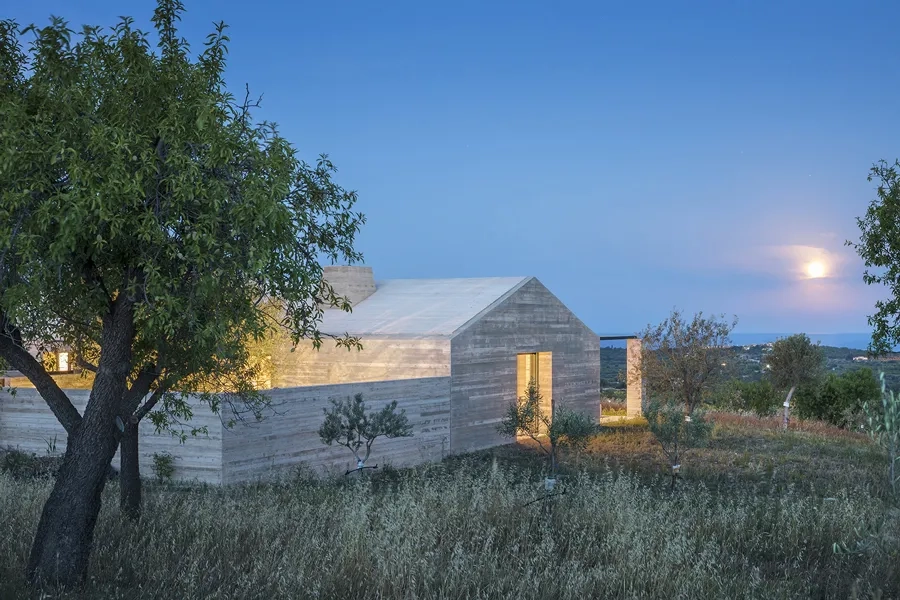 Implantée dans la pente du terrain, la Casa Bendico, enveloppée de sa double coque en béton banché, se fond dans le paysage.